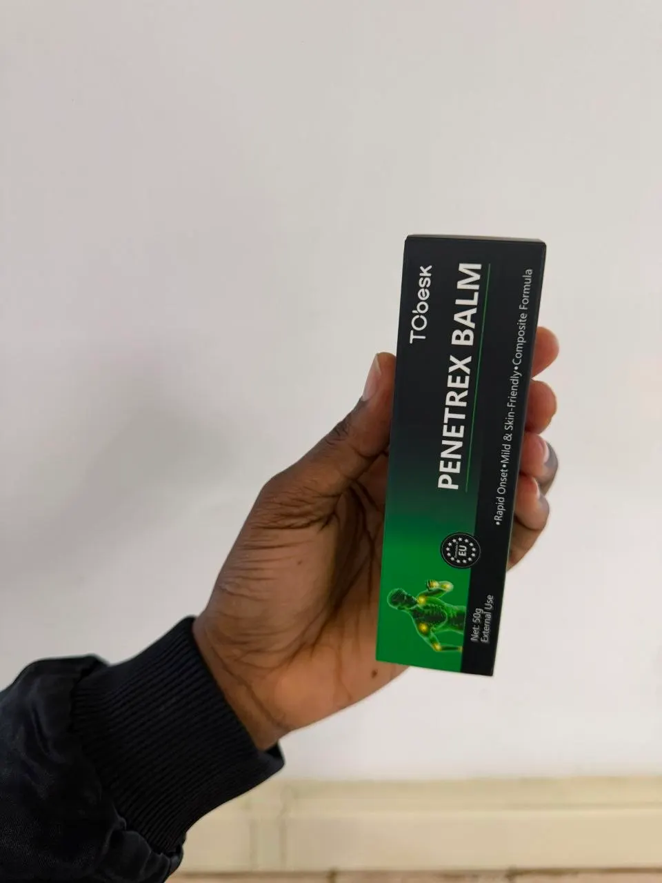 Hand holding the Penetrex Balm carton